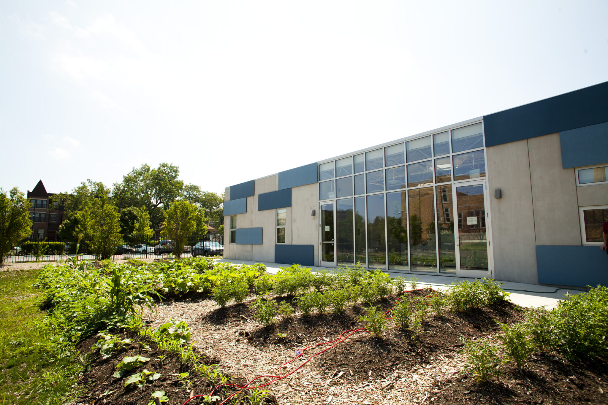 exterior photo of building with student garden in front