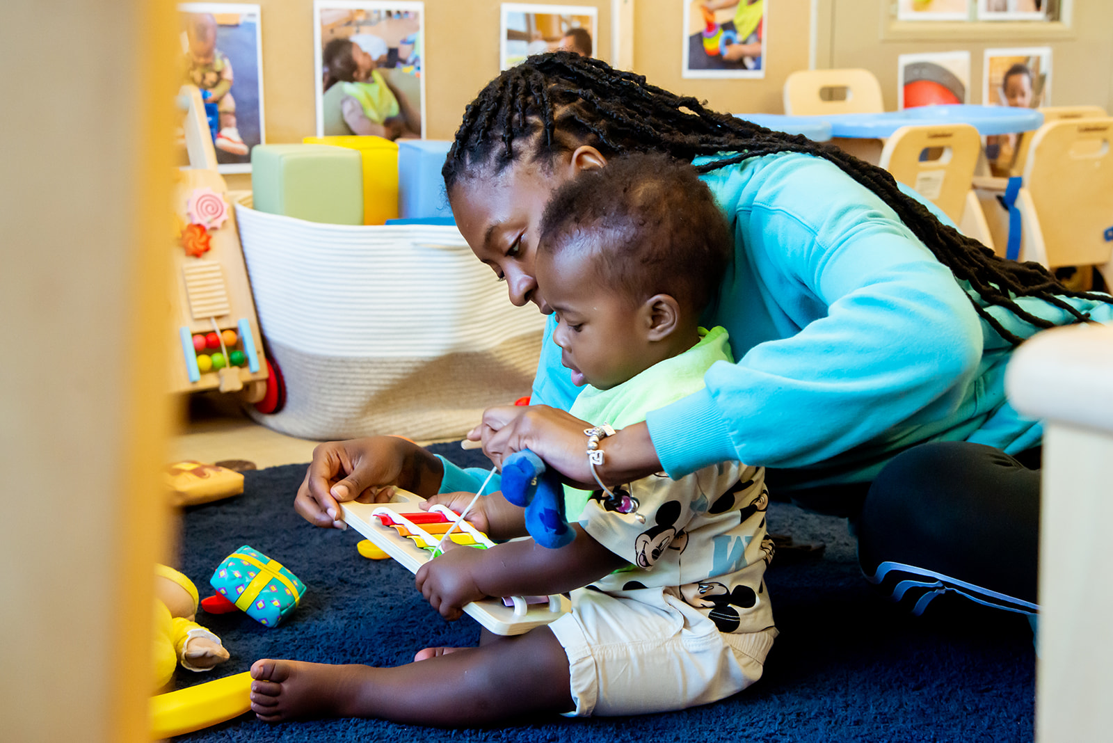 young child learning with teacher