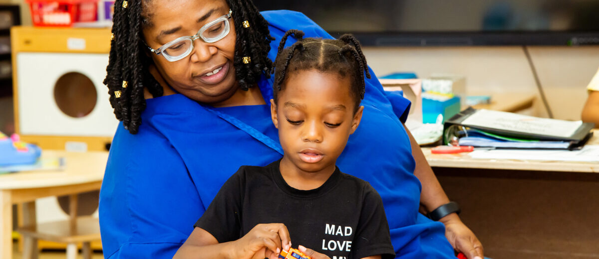 Teacher sitting with child