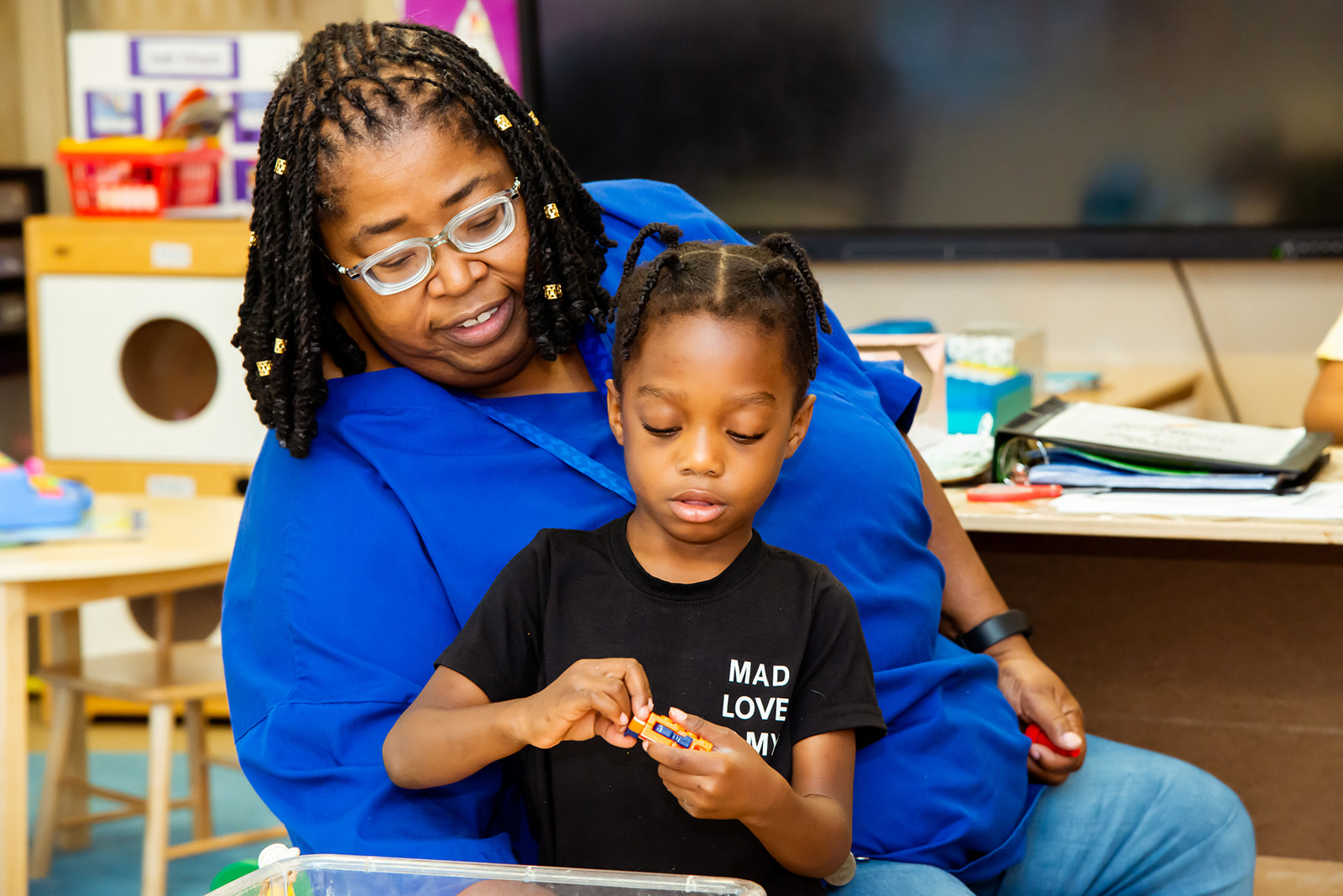 Teacher sitting with child