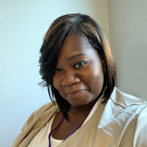 Teresa Bennett smiling at camera in office.