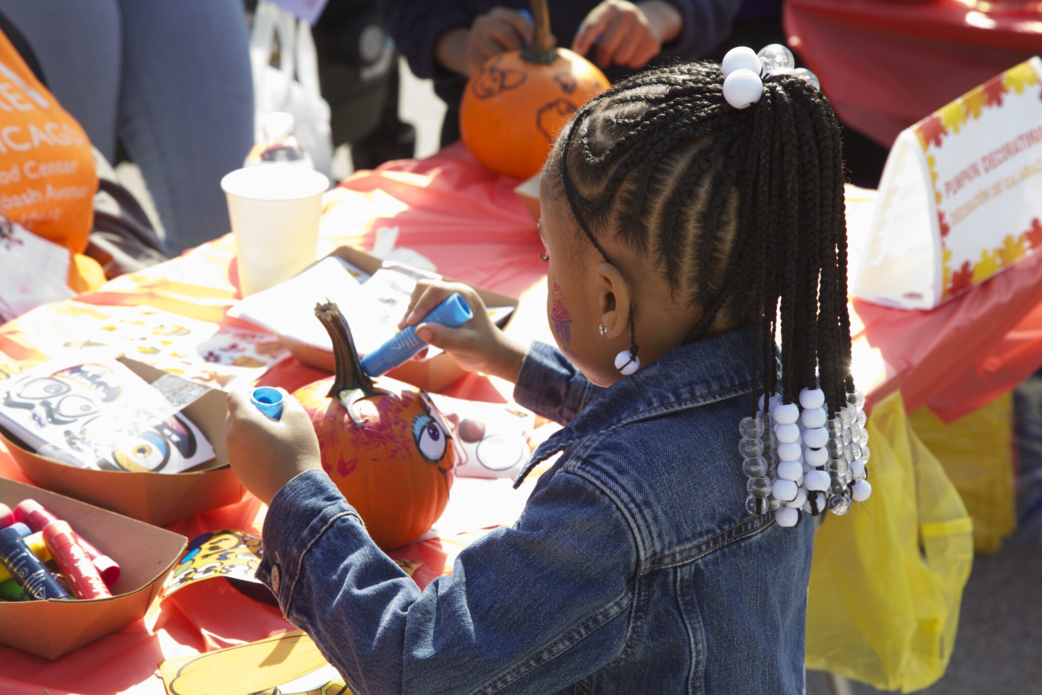 child painting pumpkin